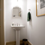 pedestal sink with mirror in powder room