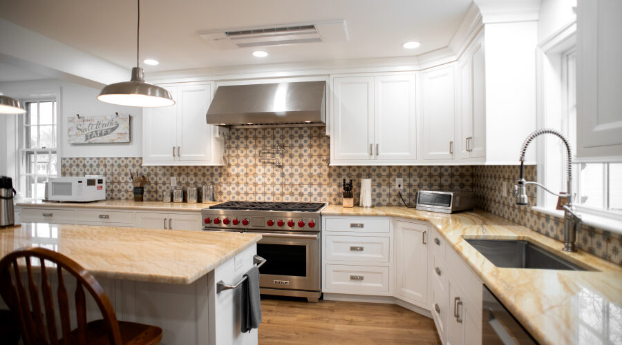 DSC_5104 kitchen addition with white cabinets, wooden counters, tile backsplash, and island