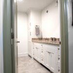 double sink with white cabinets in master bathroom