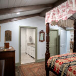 pink floral canopy bed and new green doors in master bedroom addition