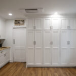 pantry area with floor to ceiling cabinets and coffee station