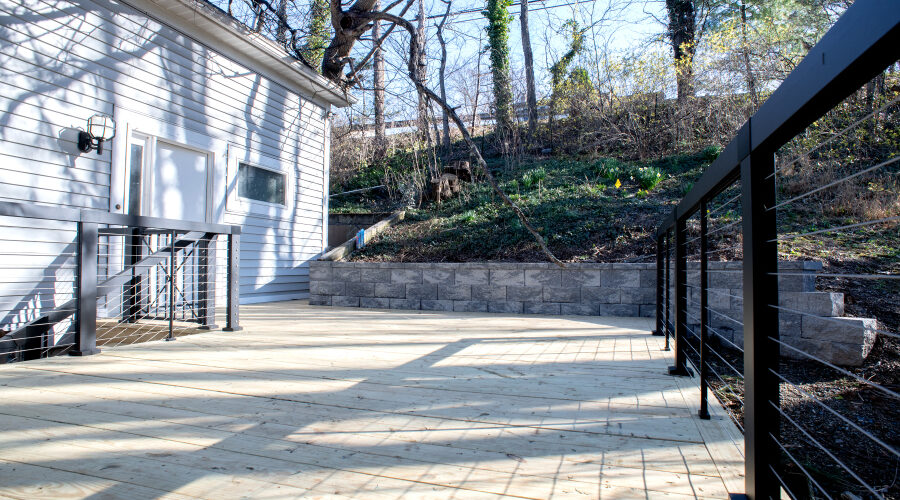 pressure-treated wood and black cable railings on new deck