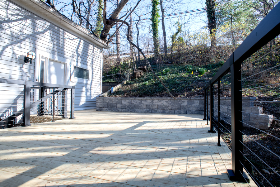 pressure-treated wood and black cable railings on new deck
