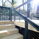 stairs with cable railing on deck