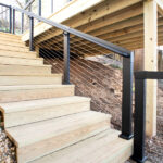 wooden stairs with cable railing on deck