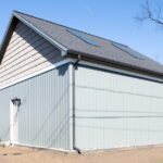 left side view of a detached garage with solar panels on the roof