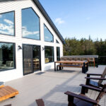 deck with lounge chairs, bar seating, and dining table