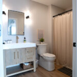 bathroom with new sink, toilet, and shower