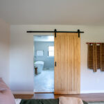 sliding wooden door to master bathroom