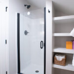 walk in shower and shelves in bathroom