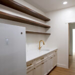 pantry with sink, fridge, and shelving