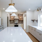 large kitchen in a new home with a brick backsplash