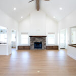 new living room with wooden floors, gas fireplace, and ceiling fan