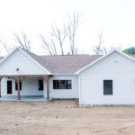 back view of a new home with a back porch