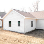 back left side view of new home with white siding