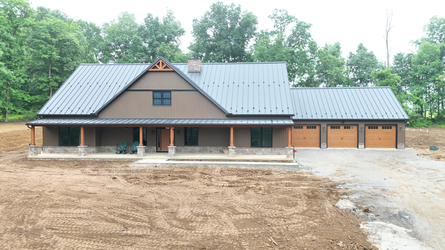 DJI_20260527080141_0003_D new home with front porch and three garage doors