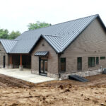 side view of new home with stone veneer