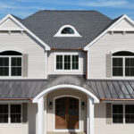 metal porch roof, shingle roof, and multiple windows for new home