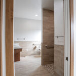 bathroom with double sinks and walk in shower