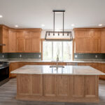 new kitchen with island, brown cabinets, and light