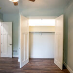 room with gray walls and closet with double doors
