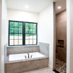 bathtub under large windows