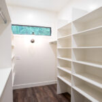 large walk in closet with shelf and hanging space
