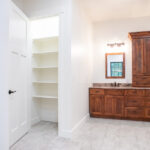 double sink and closet storage in bathroom