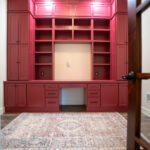 large desk with built in cabinets, painted red