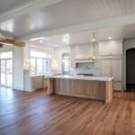 kitchen with new appliances, island, and wood floors