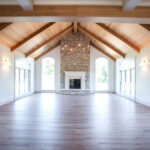 stone fireplace in living room with wood ceiling