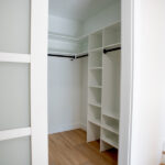 walk in closet with shelves and slider door