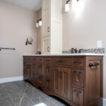 bathroom with two sinks and built in storage