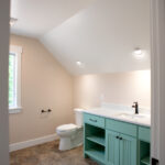 new bathroom with green cabinets