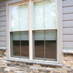 new windows, siding, and stone veneer