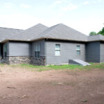 side view of new home with stone veneer