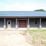 detached garage with columns and stone