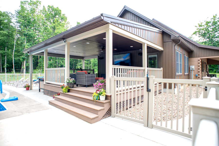 DSC_8653 outdoor living space with roof, vinyl railings, and tv