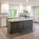 new kitchen with island and white cabinets