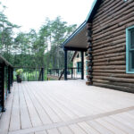 log cabin home with wood deck