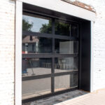 new garage door with black frames and clear glass