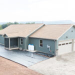 exterior of a new home with two garage doors and back porch