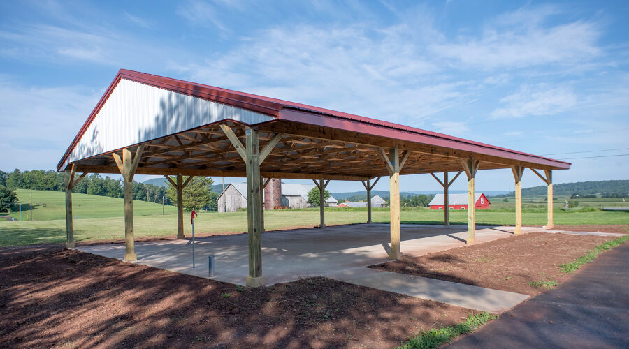 large pavilion with a red roof and white side walls