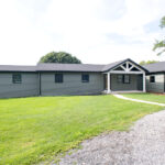 home after a renovation with new siding, porch, windows