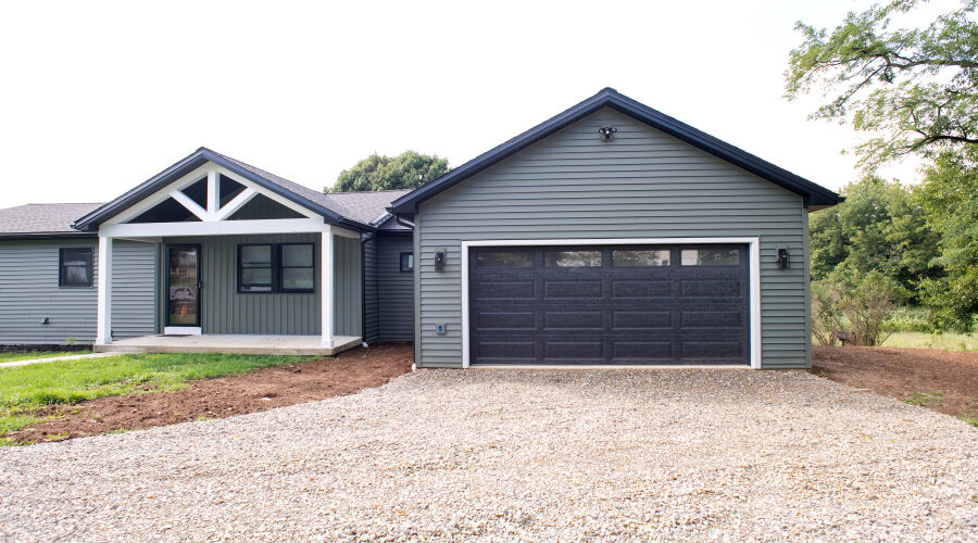 DSC_0546 garage addition with gray siding and windows in garage door
