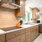 new stove, sink, and cabinets in remodeled kitchen