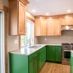 kitchen with sink, upper cabinets, and custom lower cabinets