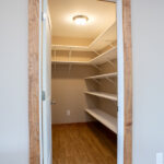 pantry space with wood trim around door