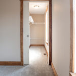 door to closet space with wood trim
